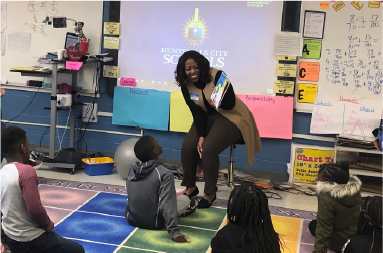 AvMC Employee reading to children for Read Across America